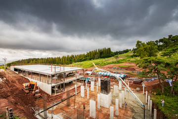 people working at site construction under rain cloud.