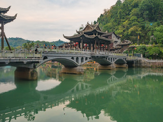 Fototapeta premium fenghuang,Hunan/China-16 October 2018:Tourist on Fenghuang old town bridge with Scenery view of fenghuang old town .phoenix ancient town or Fenghuang County is a county of Hunan Province, China