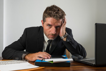 young desperate and frustrated businessman working stressed and upset sitting at office computer...