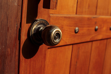 door knob on the wood door and light of sun.