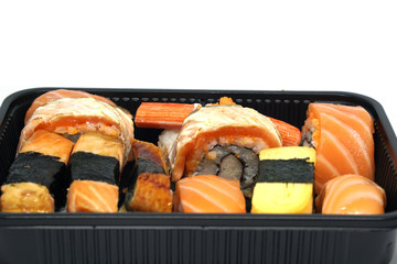 Japanese Food in black box set isolated on white background - Unagi sushi , salmon sushi - Tamago yaki  - aerial view