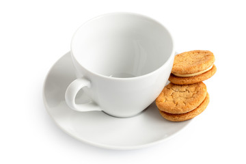 White cup, saucer and two biscuits.