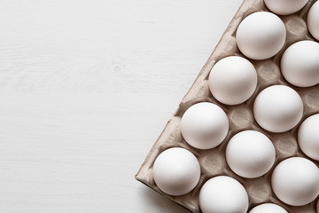 Detail of white chicken eggs in paper tray. - 313278696