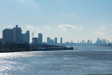 The East River between Queens and Manhattan in New York City with the Williamsburg Bridge in the distance