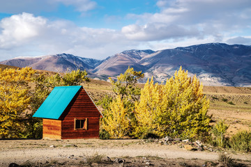 Wooden guardhouse. Chui steppe, Kyzyl-Chin valley. Autumn in the Altai Mountains