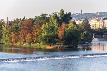 Strelecky Island with weir on Vltava river near National Theatre and the Charles Bridge, Prague,...