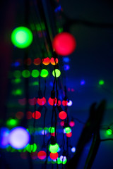 Multi-colored glare from garlands in the form of abstraction in the dark