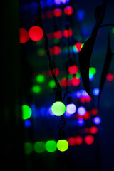 Multi-colored glare from garlands in the form of abstraction in the dark