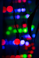 Multi-colored glare from garlands in the form of abstraction in the dark