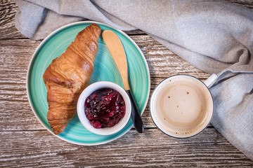 Fresh croissant on wooden board.