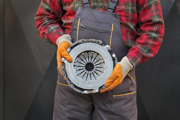 Automotive, clutch part in mechanic hands