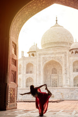 Indian woman in red saree/sari in the Taj Mahal, Agra, India