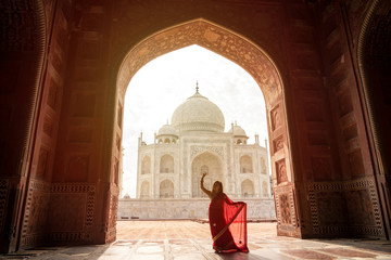 Fototapeta na wymiar Indian woman in red saree/sari in the Taj Mahal, Agra, India