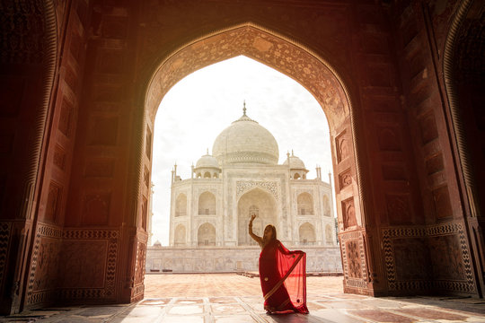 Indian woman in red saree/sari in the Taj Mahal, Agra, India