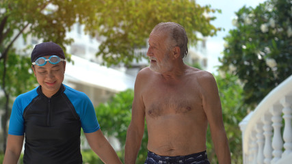 Senior Couple Relaxing In Swimming Pool