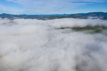 A low blanket of clouds drifts slowly over the rural landscape of central Oregon. This beautiful region is known for its extensive farming and nearby logging communities.
