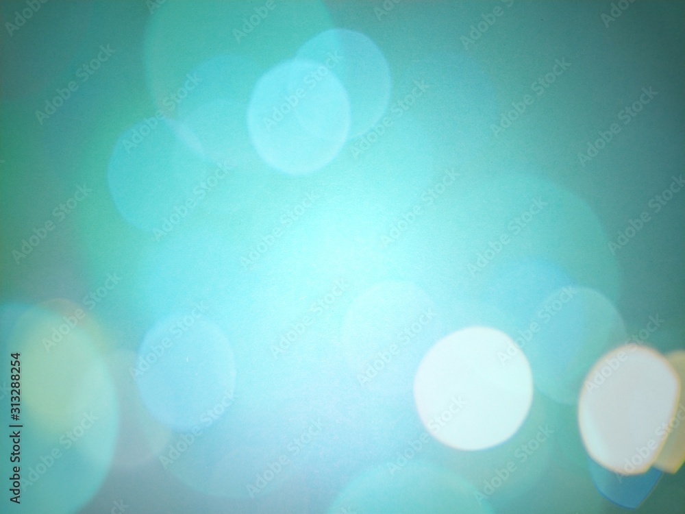 Aufkleber blue-green background with dark vignette on the sides and delicate sparkling bokeh in the middle of 