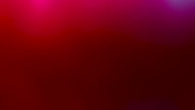 Close up view of iridescent flickering shimmering twinkling red color. Red background.