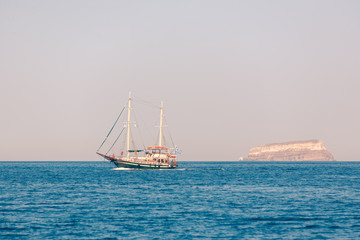 Fototapeta na wymiar View on the seaside of Santorini island with ship on the sea