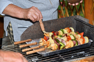 Homemade barbecue at the cottage with meat bacon and vegetables