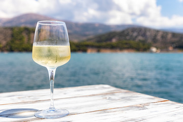 glass of white wine on beach