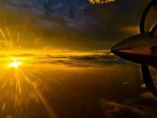 Naklejka na ściany i meble Views out the aircraft window sunset clouds beach ocean