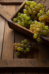 Green grapes on rustic boards