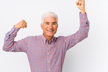 Senior caucasian man isolated celebrating a special day, jumps and raise arms with energy.