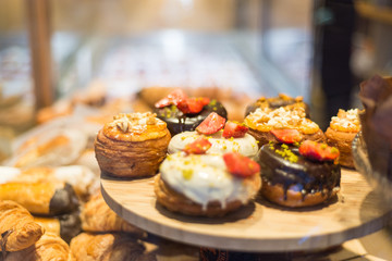 An assortment of pastries topped with cream, chocolate and fruit