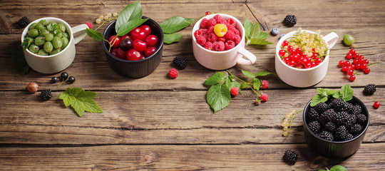 different berries on old wooden background