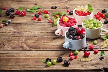 different berries on old wooden background