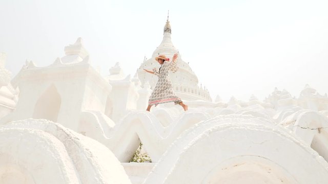 Young Woman Traveler Having Fun In Famous Hsinbyume Pagoda. Mandalay, Myanmar. 4K Steadycam Slow Motion Footage.