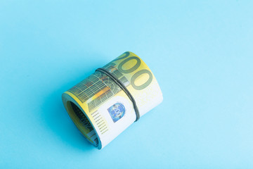 Money and income concept. Euro cash banknotes on a blue background. Saving and spending money