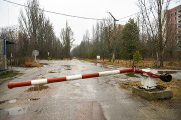 The barrier is blocking the road to ghost town of Prypiat in Chornobyl Exclusion Zone, Ukraine. December 2019