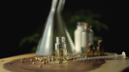 Glass jars with cbd oil and seeds. Hydroponic and aquaponic of biological and ecological cannabis hemp plant, herbal pharmaceutical.