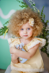 little blonde girl in a yellow suit for Easter