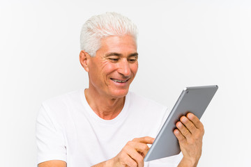 Mature caucasian man holding a tablet