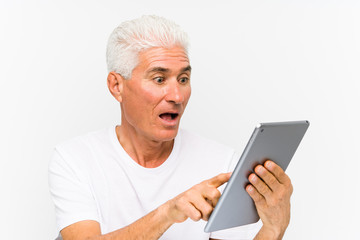 Mature caucasian man holding a tablet