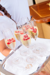 Vertical shot of drinks with red berries on the tray