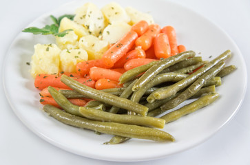 Steamed vegetables on white plate