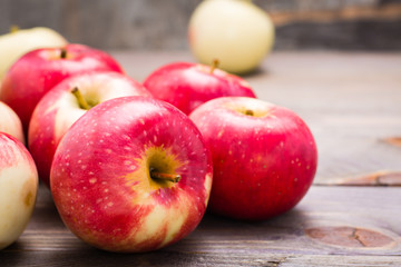 Fresh ripe red apples on a wooden background