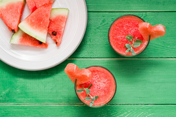 Fresh watermelon blended drink with mint leaves and a heart of watermelon in glasses and slices of...