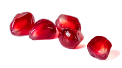 Fresh pomegranate seeds isolated on white background. Close up.