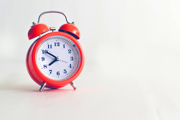 Red alarm clock on a white background. Place for text. 8.50. Red line and deadline.