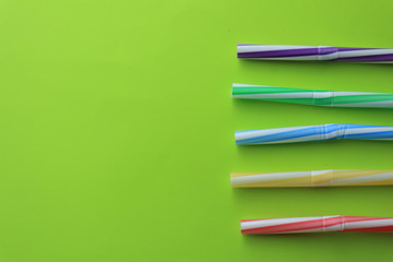 Fototapeta premium Plastic cocktail straws on color background
