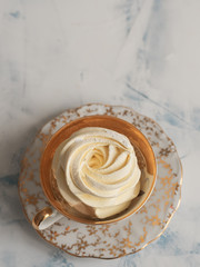 Homemade Marshmallows. Apricot Zephyr is located in a ceramic cup. Top view, copy space. Homemade sweets.