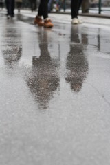 MIRRORED STREET IN RAIN. CITYSPACE IN HALLSTATT, AUSTRIA