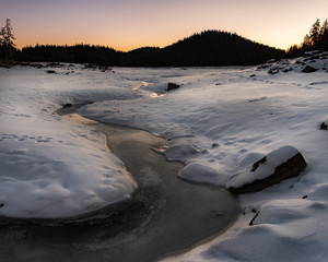 Sunrise in the winter mountain. Bottom of the empty lake Shiroka poliana in Rhodope mountain, Bulgaria