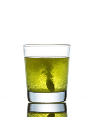 The effervescent tablet dissolves in a glass of water