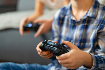 Closeup on kids hands playing console games